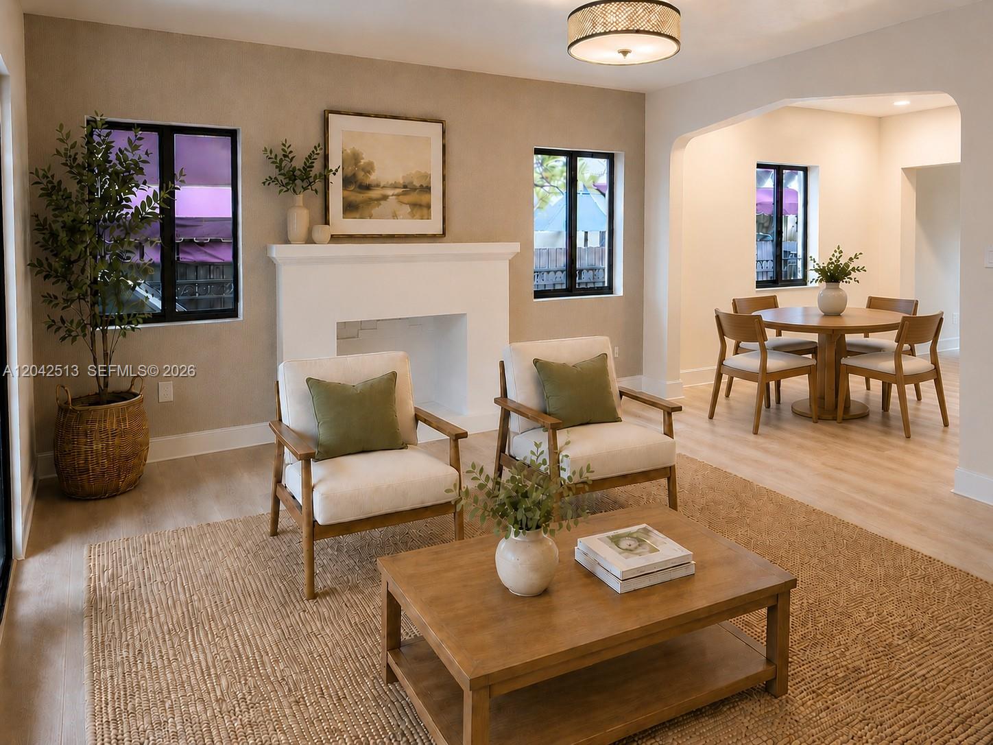 A living room features a fireplace, two armchairs, a coffee table, and an adjacent dining area — 3053 SW 21st St, Miami FL 33145, MIAMI, FL