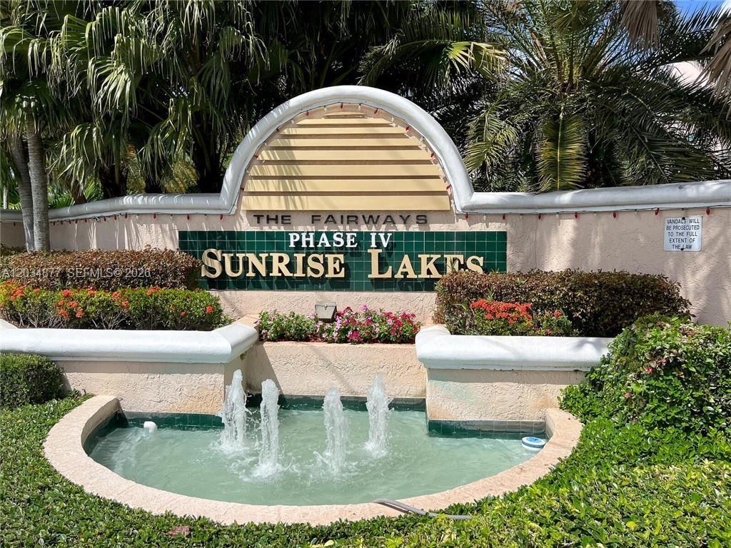 An exterior sign for The Fairways Phase IV Sunrise Lakes featuring a small water fountain — 10312 NW 24th Pl # 106, Sunrise FL 33322, SUNRISE, FL