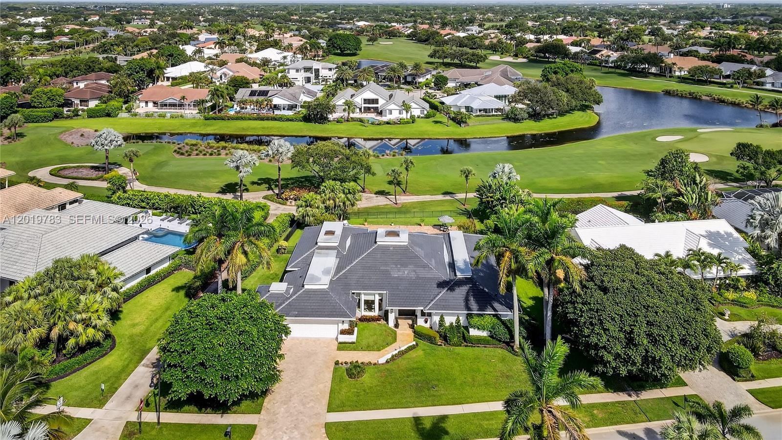 An aerial view shows a single-story house with a dark roof near a golf course — 4431 Bocaire Boulevard, Boca Raton FL 33487, BOCA RATON, FL