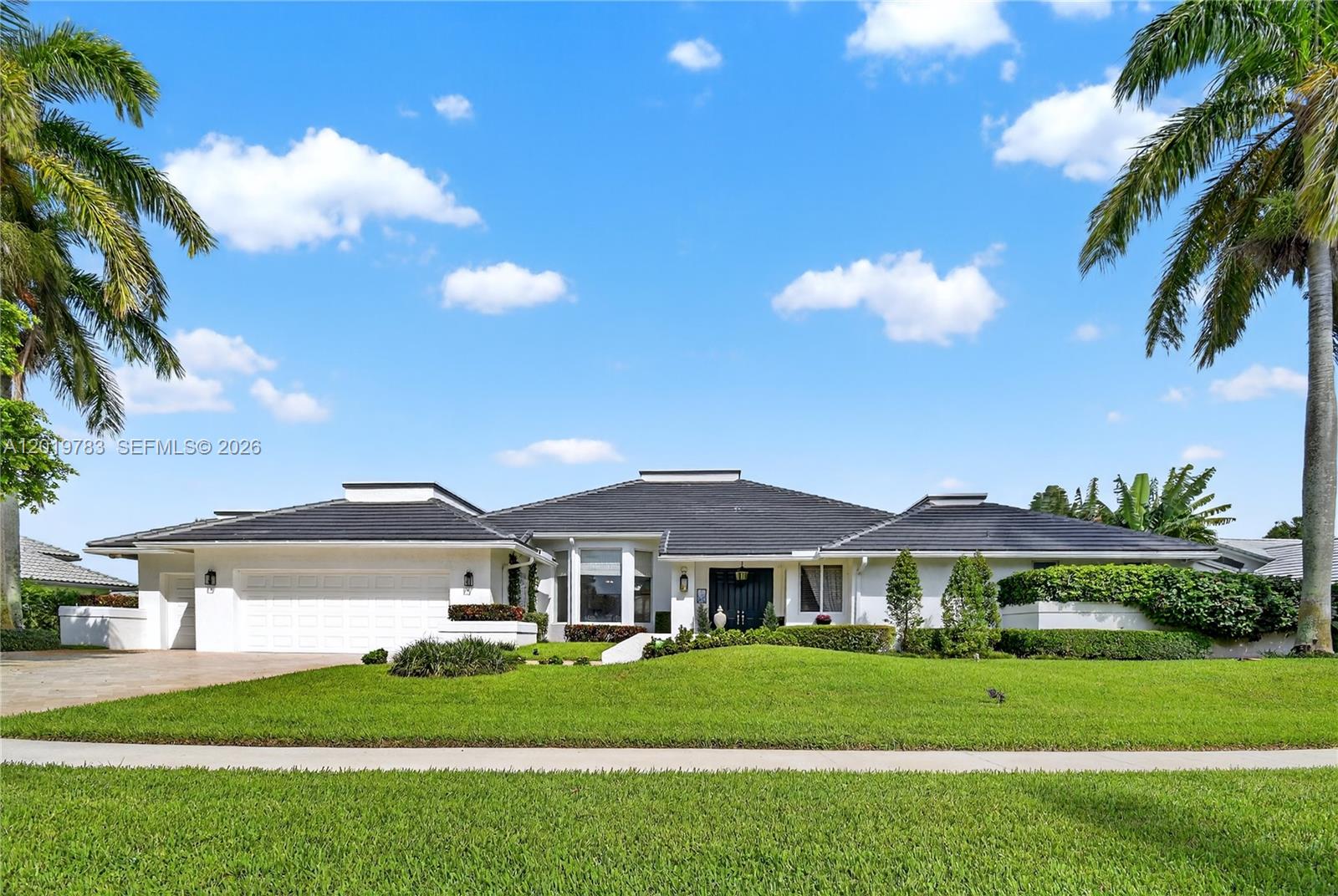 A single-story white house with a dark tiled roof and palm trees in the yard — 4431 Bocaire Boulevard, Boca Raton FL 33487, BOCA RATON, FL