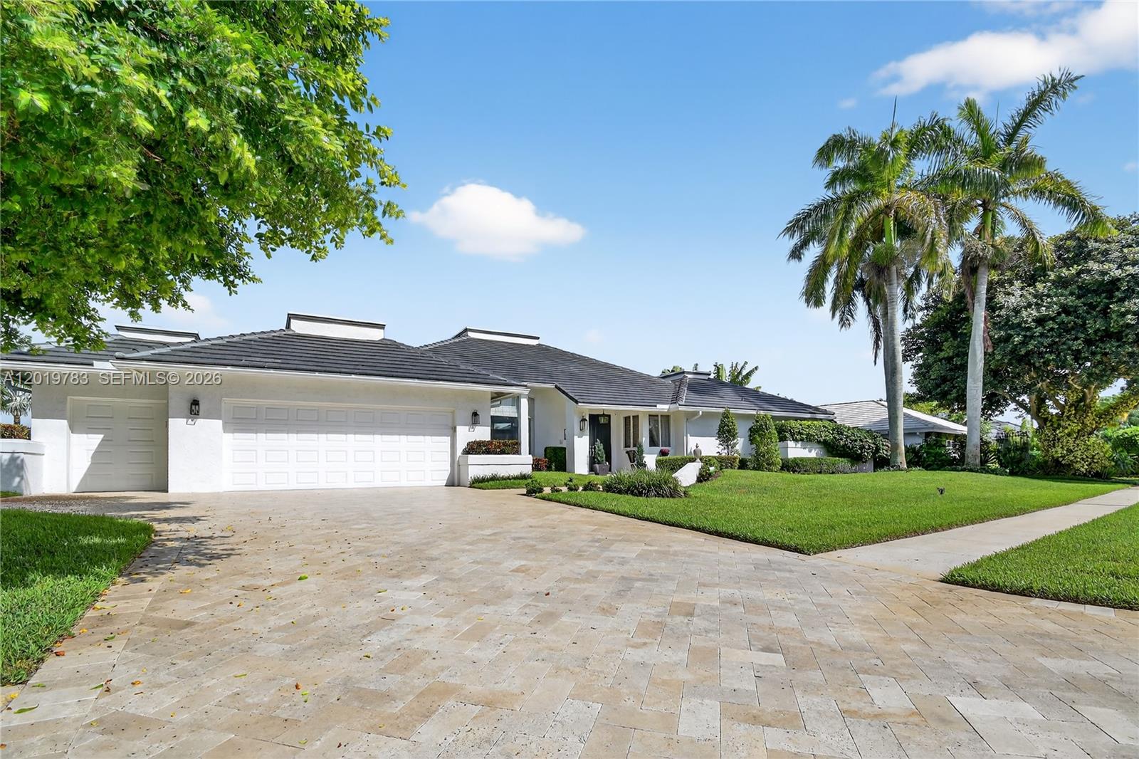A single-story white house with a dark tiled roof and a paved driveway — 4431 Bocaire Boulevard, Boca Raton FL 33487, BOCA RATON, FL