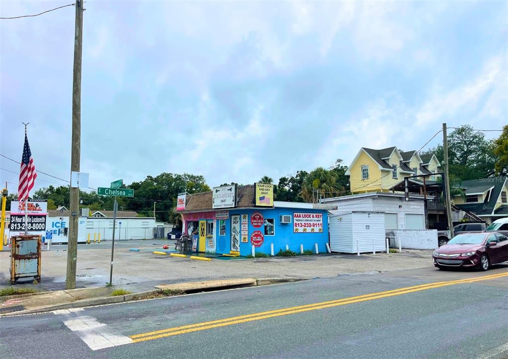A small blue commercial building with a locksmith shop sits on a paved corner lot — 4330 N NEBRASKA AVENUE, TAMPA, FL