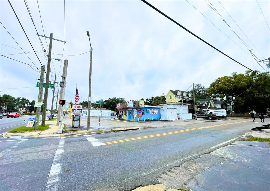 A street-level view shows a small blue commercial building at a corner intersection — 4330 N NEBRASKA AVENUE, TAMPA, FL