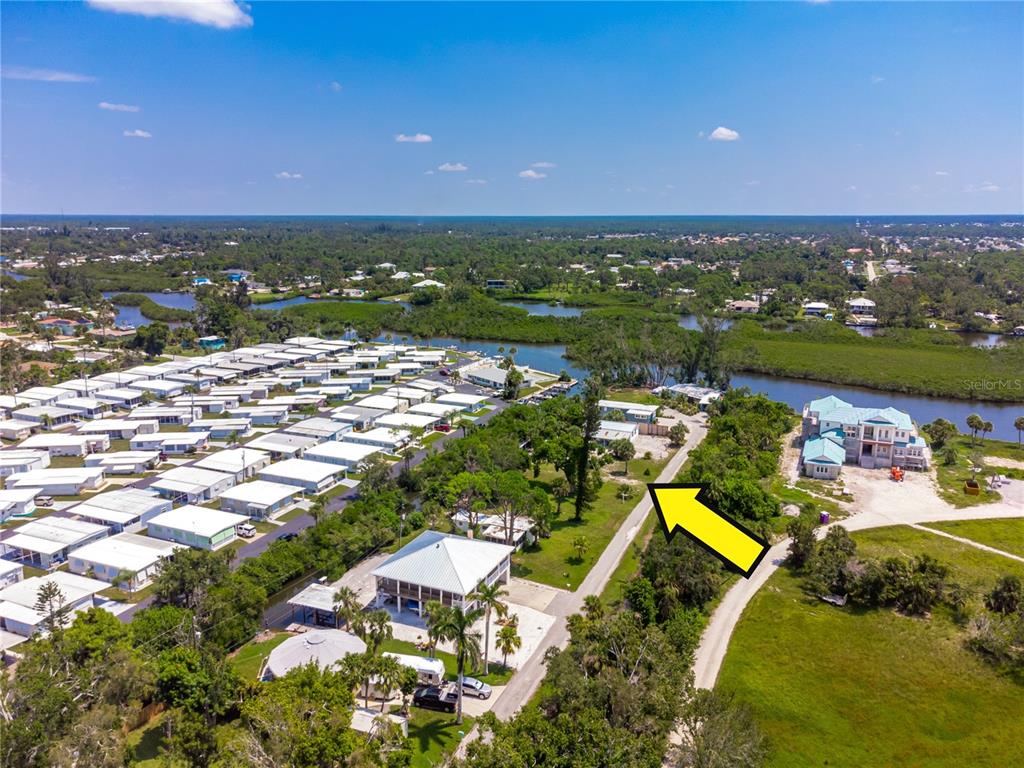 An aerial view shows a residential area with mobile homes, a large house, and a road — 240 RIVERVIEW AVENUE, ENGLEWOOD, FL