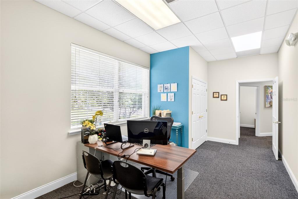 A home office features a wood desk, a blue accent wall, and a window with blinds — 365 WEKIVA SPRINGS ROAD UNIT Suite 201 and 222, LONGWOOD, FL