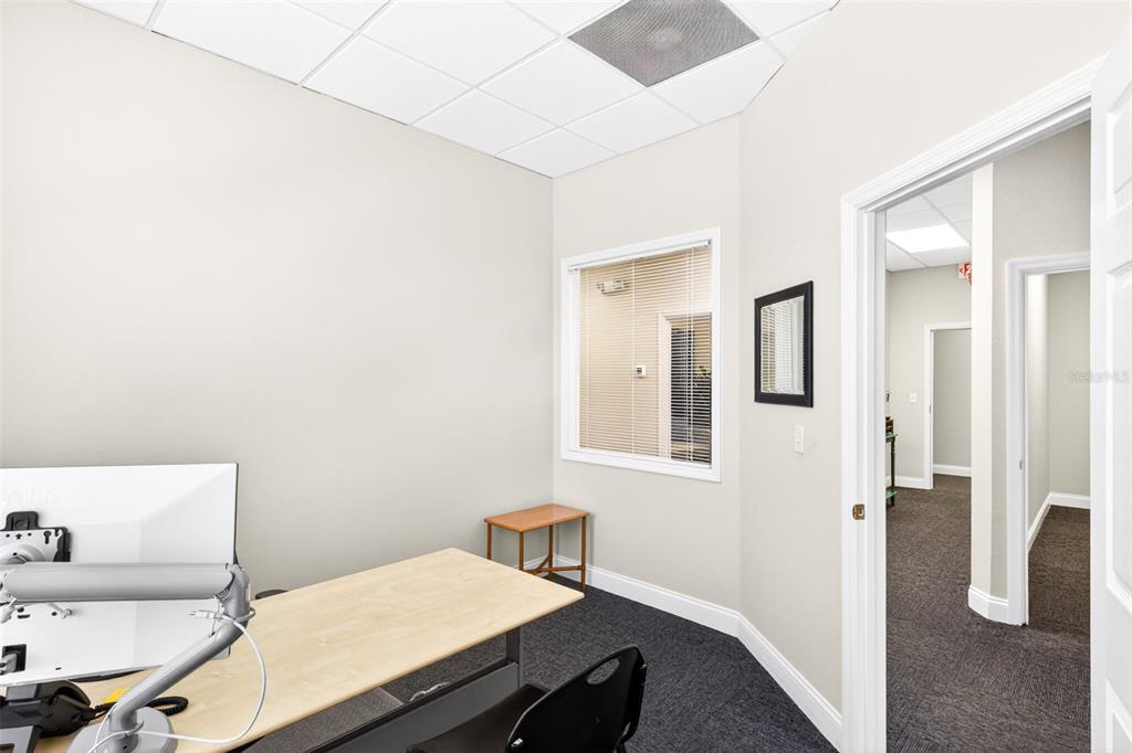 An office with a desk, a window looking into a hallway, and dark carpeting — 365 WEKIVA SPRINGS ROAD UNIT Suite 201 and 222, LONGWOOD, FL