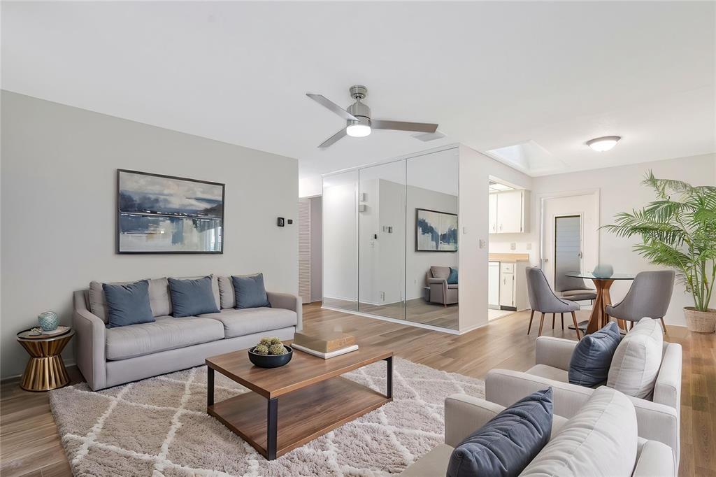 A living room features light wood flooring, a ceiling fan, and a sliding glass door — 2261 SHELLY DRIVE UNIT D, PALM HARBOR, FL
