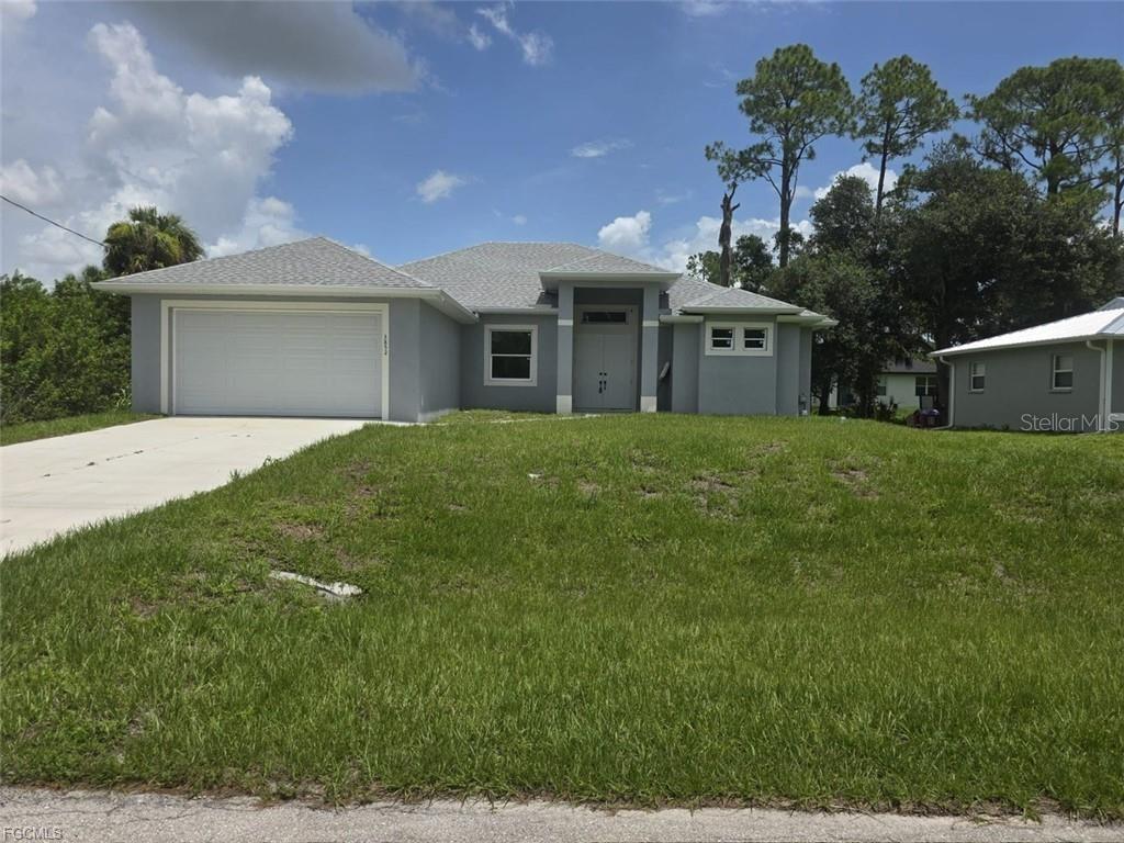 A single-story gray house with a two-car garage and a front lawn — 3852 HOPEVALE STREET, FORT MYERS, FL