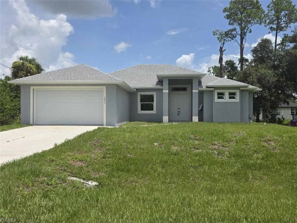 A single-story gray house with a two-car garage and a front entrance porch — 3852 HOPEVALE STREET, FORT MYERS, FL