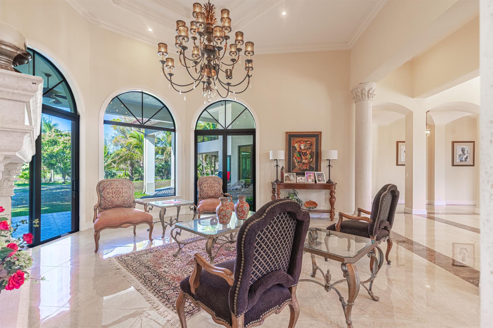 A formal living room features a chandelier, arched windows, marble floors, and traditional furniture — 2943 B Road, FL 33470, FL