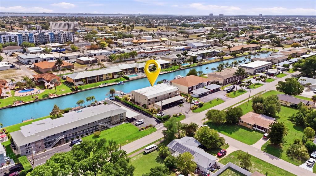 An aerial view shows a multi-story apartment building with a yellow location pin — 912 SE 46TH STREET UNIT 201, CAPE CORAL, FL