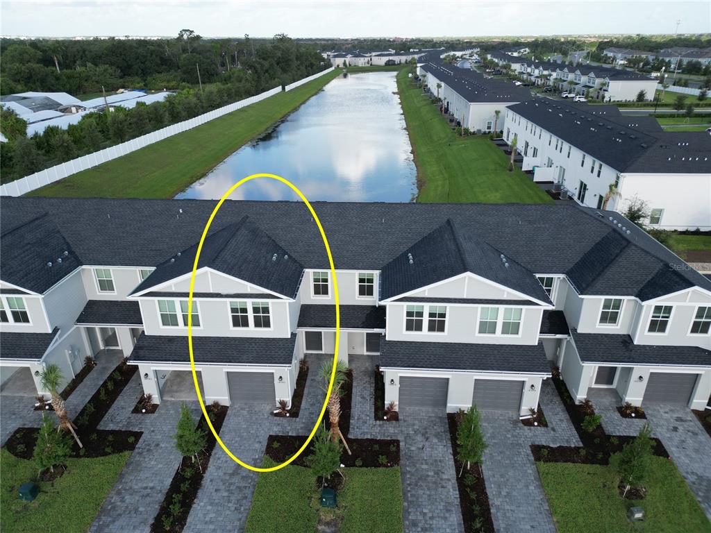 An aerial view shows a two-story townhouse unit highlighted by a yellow oval — 14538 LILAC SKY TERRACE, BRADENTON, FL