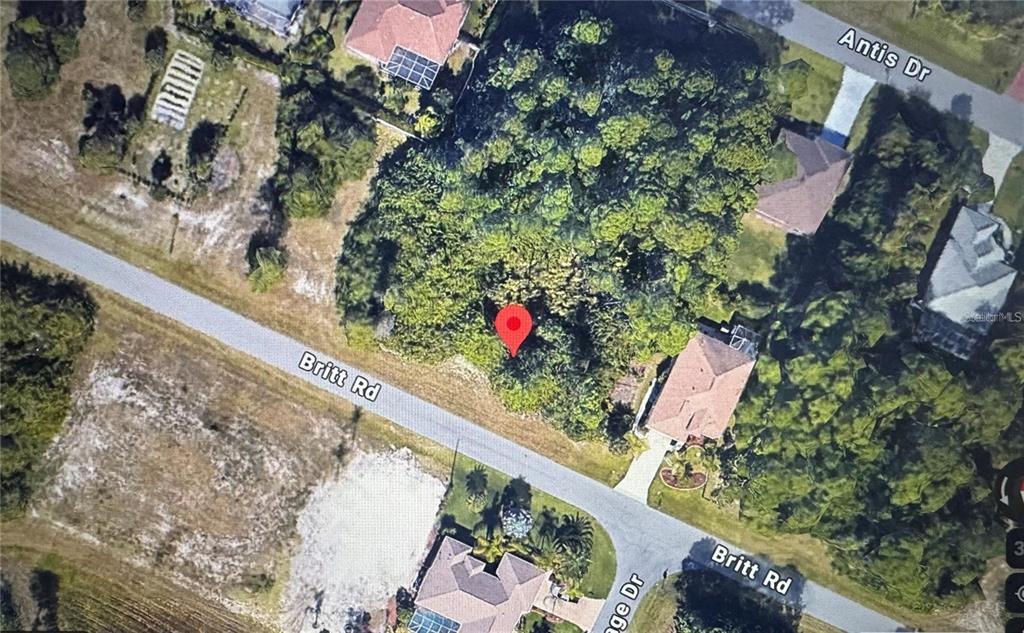 This is an aerial map view showing a wooded lot marked with a red pin — 118 BRITT ROAD, ROTONDA WEST, FL