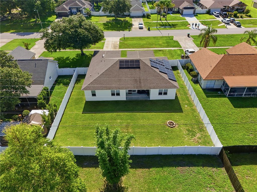 An aerial view of a single-story house with solar panels and a fenced backyard — 2228 BANCROFT BOULEVARD, ORLANDO, FL