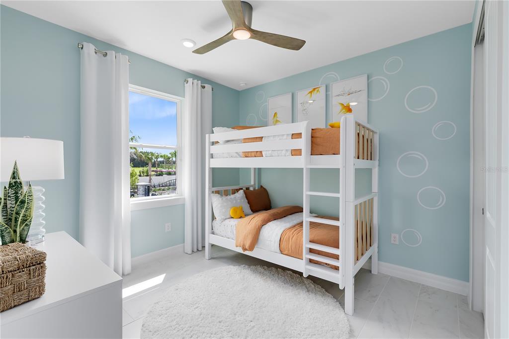 A bedroom features a white bunk bed, light blue walls with bubble decals, and a window — 5237 HANDSOME HILLS DRIVE, MOUNT DORA, FL