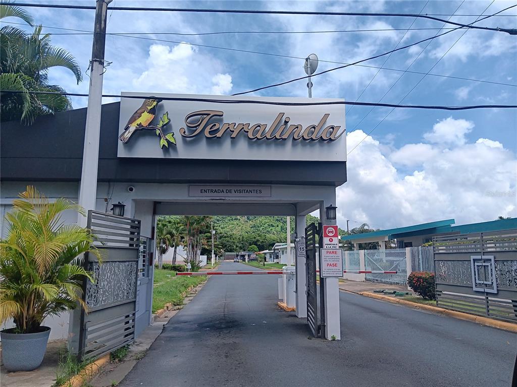 The entrance gate to the Terralinda residential community features a sign and a security barrier — URB. TERALINDA CALLE TOLEDO UNIT #6, CAGUAS, PR