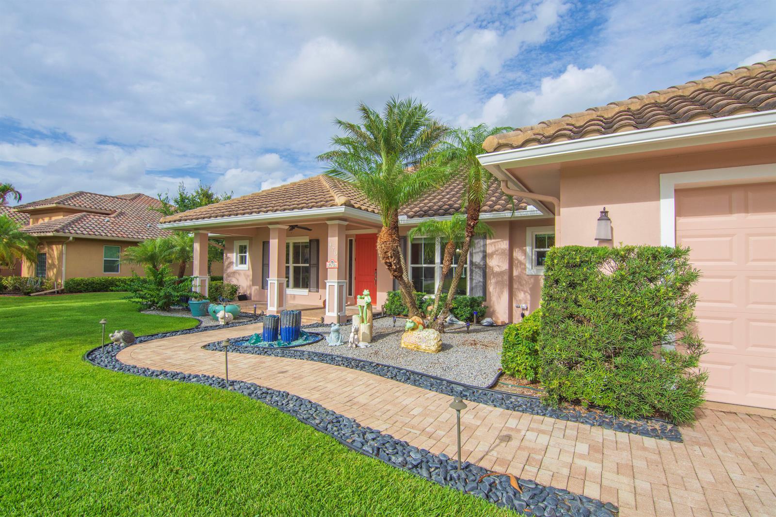 A single-story house with a peach exterior, tile roof, brick walkway, and palm trees — 470 Pittman Avenue, Vero Beach FL 32968, VERO BEACH, FL