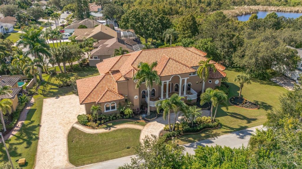 An aerial view of a two-story tan house with a terracotta tile roof — 1079 ASHLAND AVENUE, TARPON SPRINGS, FL