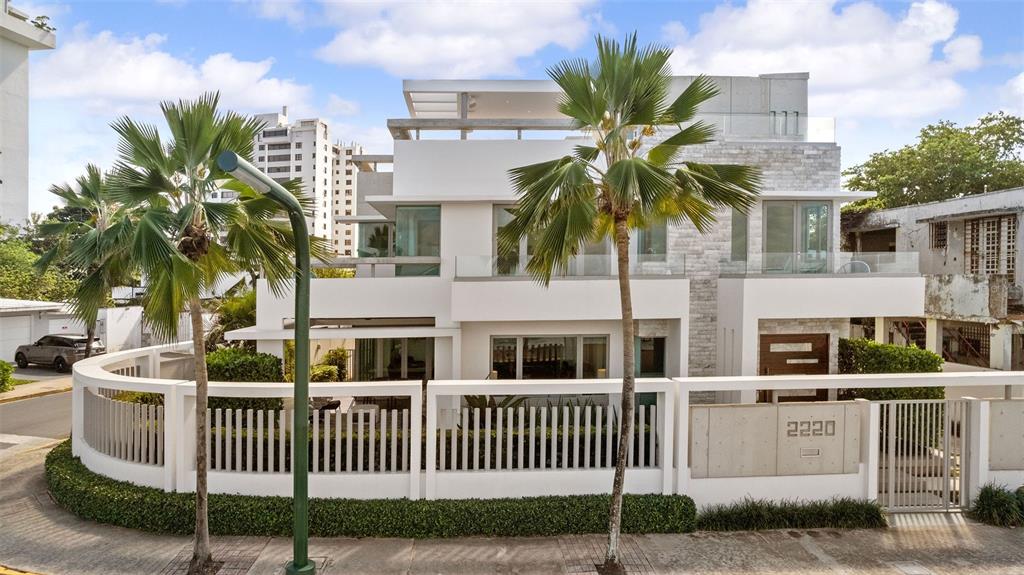 A modern white multi-story house with a fenced yard and palm trees in front — 2220 PARK BOULEVARD, SAN JUAN, PR