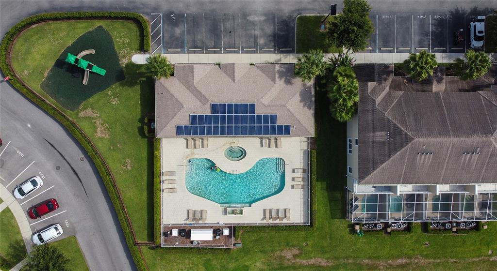 An aerial view shows a community pool, playground, parking lot, and adjacent residential buildings — 17417 PLACIDITY AVENUE, CLERMONT, FL