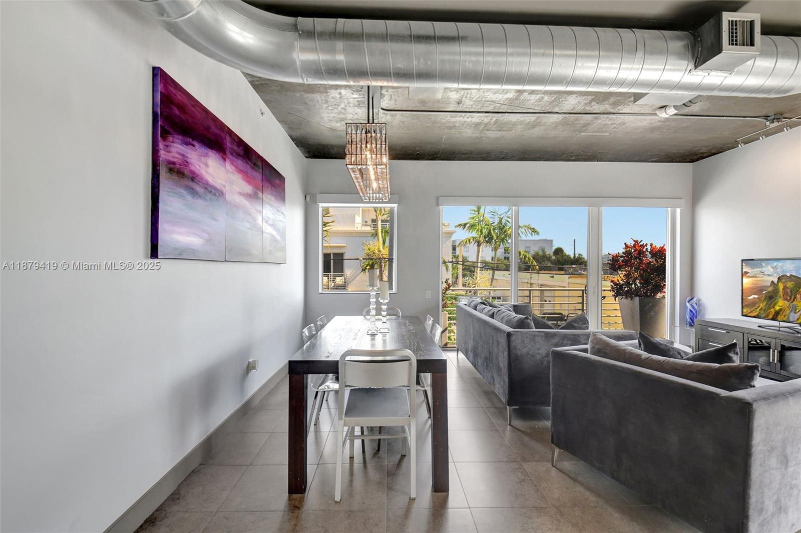 A dining area and living room feature concrete ceilings, exposed ductwork, and large windows — 110 SE 2nd ST # 203, Delray Beach FL 33444, DELRAY BEACH, FL