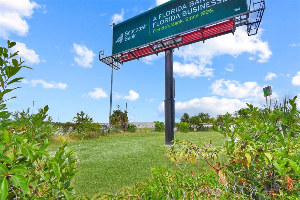 A large billboard for Seacoast Bank stands over a grassy lot under a blue sky — 7268 MORSE AVENUE, JACKSONVILLE, FL