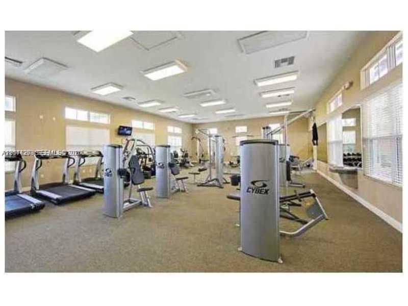A gym features various exercise machines, treadmills, and large windows with blinds — 9209 SW 227th St # 4, Cutler Bay FL 33190, CUTLER BAY, FL