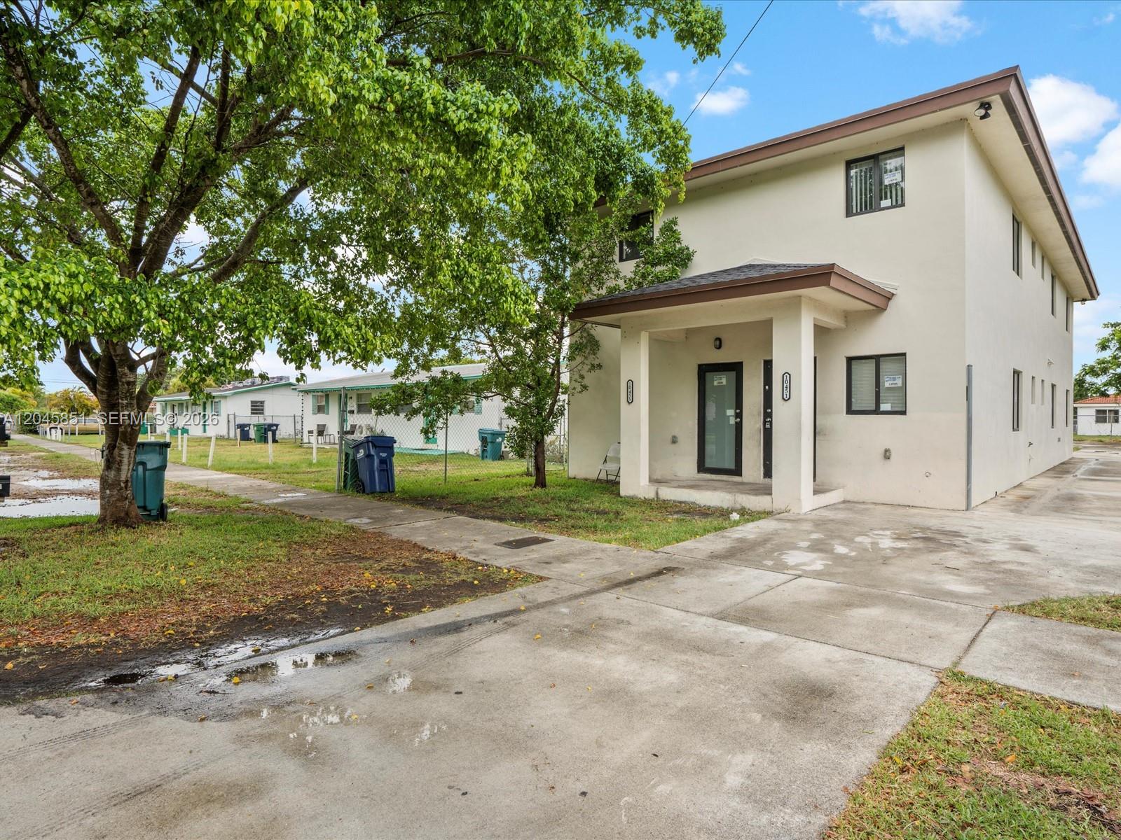 A two-story stucco building with a concrete driveway and a covered front entrance — 10455 SW 179th St # 1, Miami FL 33157, MIAMI, FL