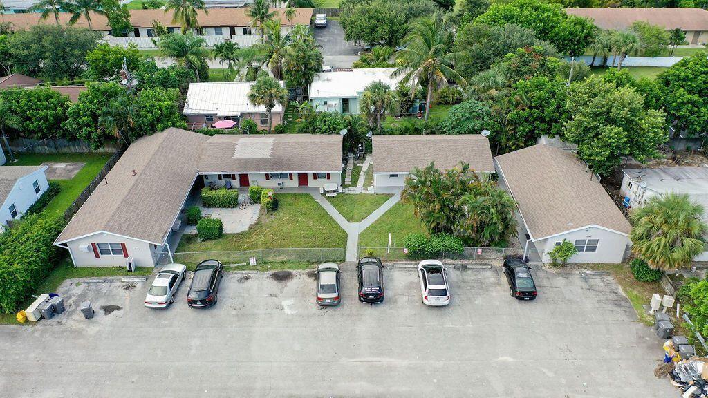 An aerial view of a single-story apartment building with a parking lot in front — 1883 Smith Drive # 2, FL 33408, FL