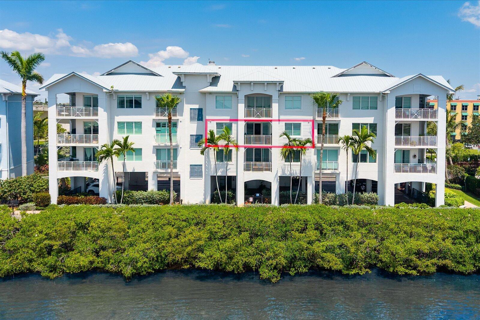 An exterior view of a white multi-story apartment building with a highlighted third-floor unit — 715 NW Flagler Avenue # 302, Stuart FL 34994, STUART, FL