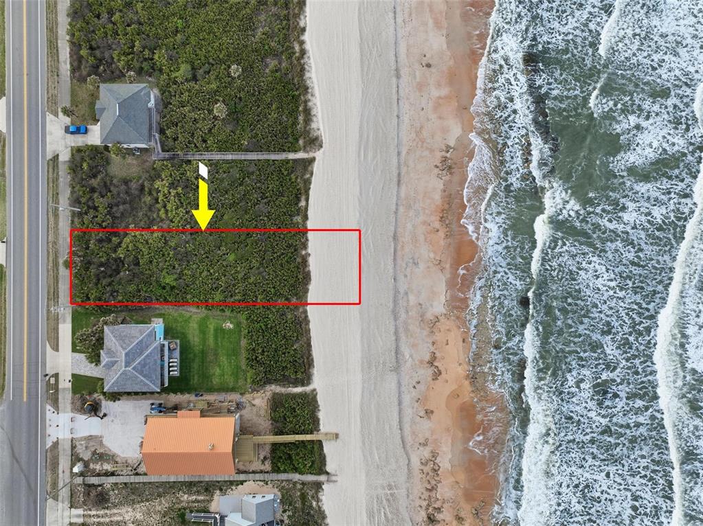 An aerial view shows a rectangular vacant oceanfront lot highlighted in red next to houses — 7103 N OCEAN SHORE BOULEVARD, PALM COAST, FL