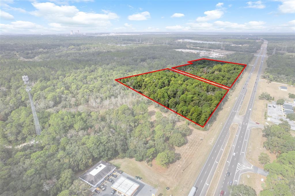 An aerial view shows two adjacent wooded lots outlined in red next to a highway — 11620 W GARNET COURT, CRYSTAL RIVER, FL