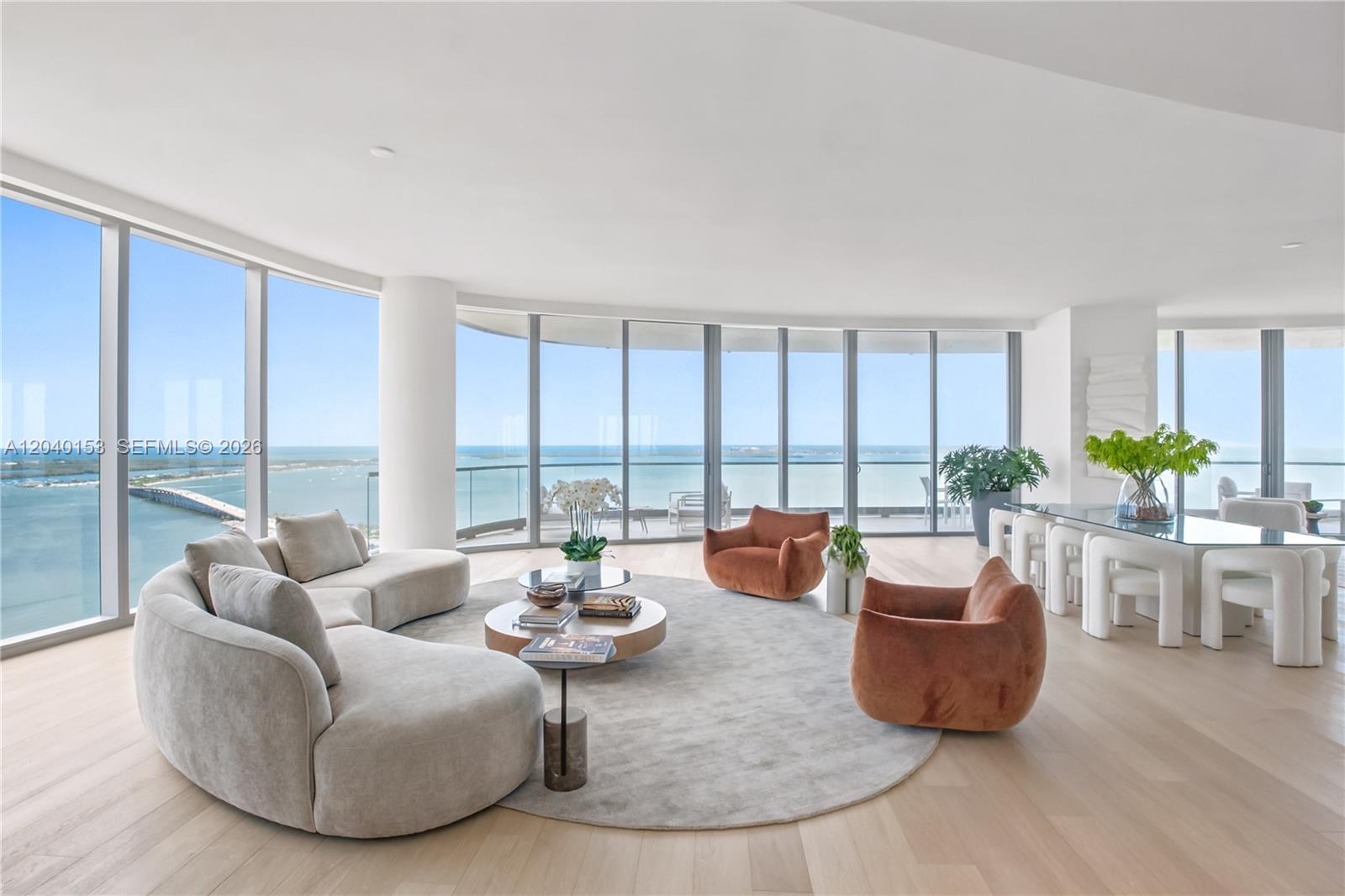 A modern living and dining area features floor-to-ceiling windows with expansive ocean views — 175 SE 25th., Miami FL 33129, MIAMI, FL
