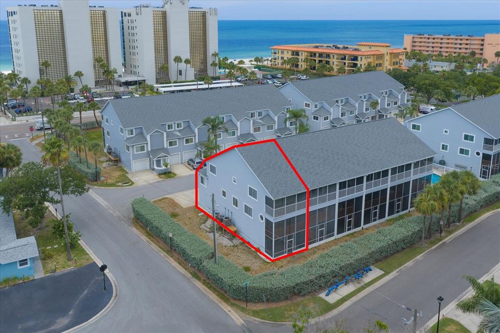 An aerial view shows a light blue multi-story townhouse with a screened-in porch — 901 HARBOUR HOUSE DRIVE, INDIAN ROCKS BEACH, FL