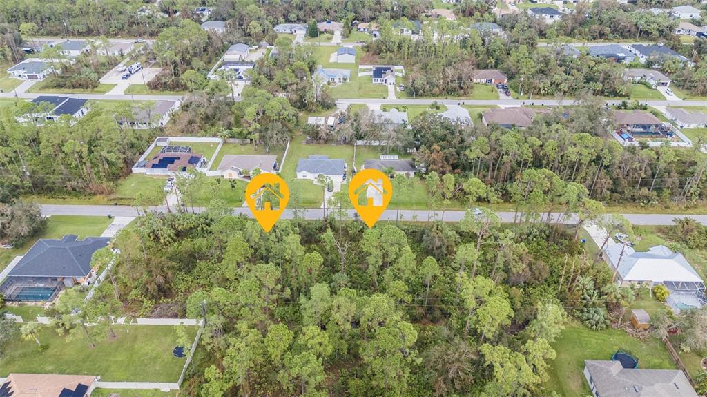 An aerial view shows two houses marked with yellow icons situated near a wooded lot — SUNBURST AVENUE, NORTH PORT, FL