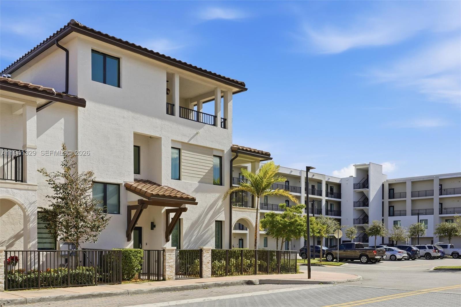 A multi-story apartment building with stucco walls, a tile roof, and a parking lot — 4250 NW 83rd Ave, Doral FL 33166, DORAL, FL