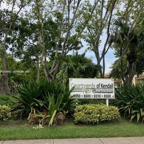 A sign for the Courtyards of Kendall Condominium stands among trees and landscaping — 8500 SW 109 Ave # 102, Miami FL 33173, MIAMI, FL