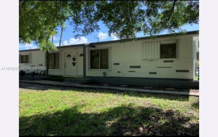 A single-story white house with a flat roof and gray decorative accents on the exterior — 401 SW 8th St # A, Hallandale Beach FL 33009, HALLANDALE BEACH, FL