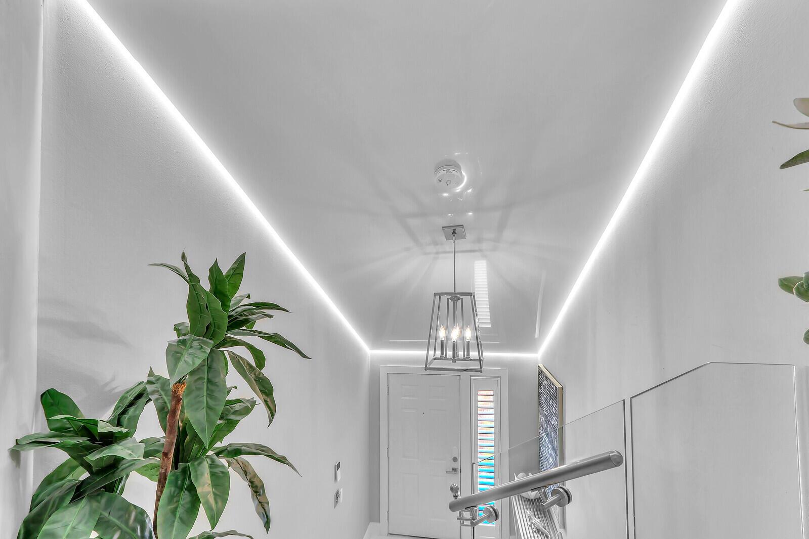 A bright entryway features a glossy white vaulted ceiling with recessed LED strip lighting — 204 Sea Oats Drive # F, Juno Beach FL 33408, JUNO BEACH, FL