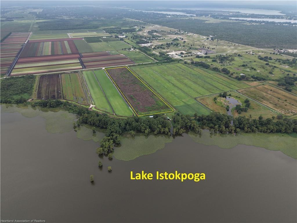 An aerial view shows a rectangular plot of land bordering the shore of Lake Istokpoga — 76 WEEKS ROAD, LAKE PLACID, FL