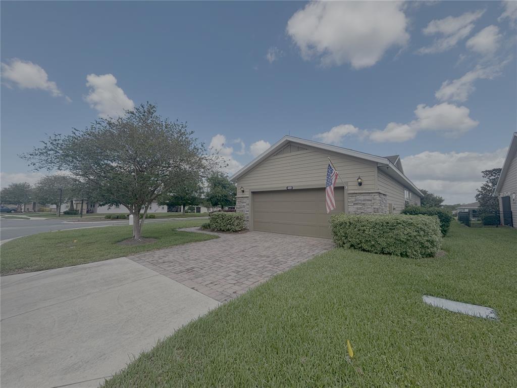 A single-story house with a paved driveway, a two-car garage, and a front lawn — 4859 NW 35TH LANE ROAD, OCALA, FL