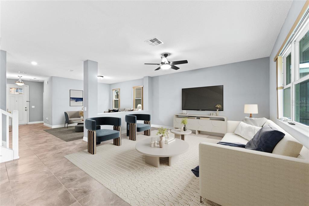 A living room features light gray walls, tile flooring, a ceiling fan, and modern furniture — 14505 WARD ROAD, ORLANDO, FL