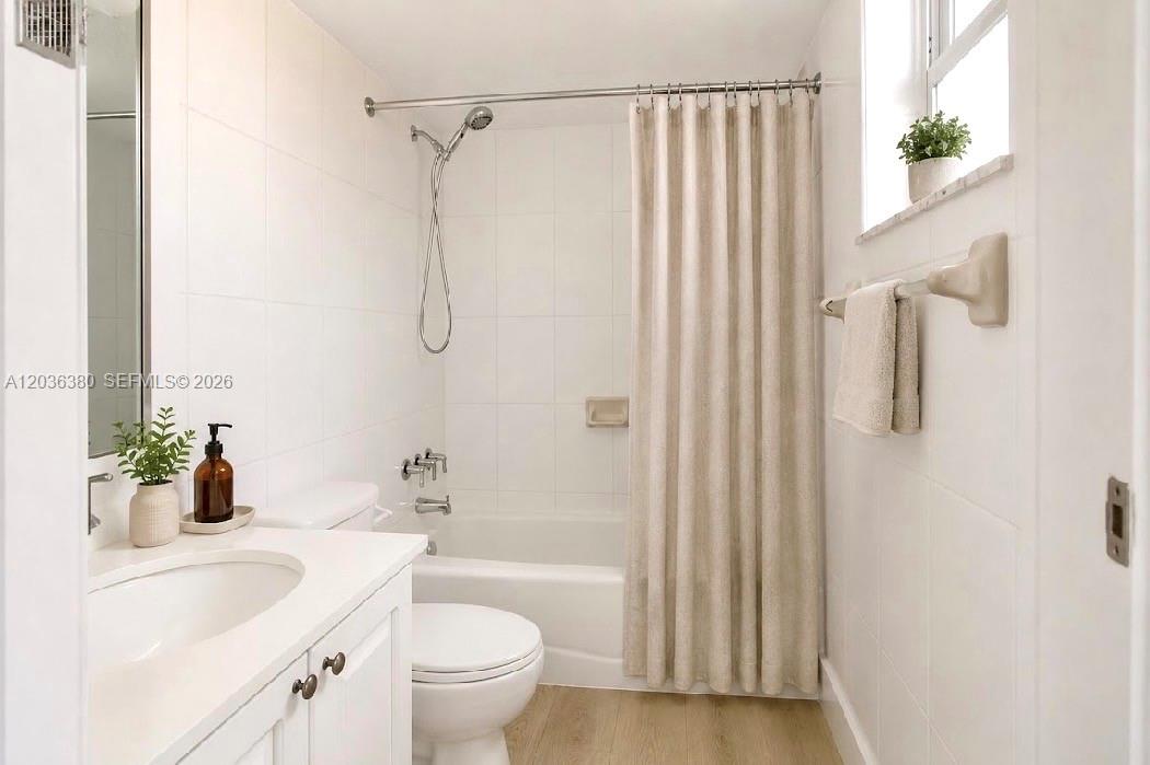 A bathroom features a white vanity, a toilet, and a shower-tub combination with white tiles — 444 SW 4th St # 204, Miami FL 33130, MIAMI, FL