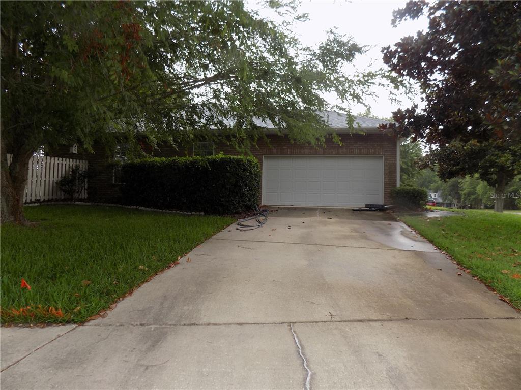 A brick house with a two-car garage and a concrete driveway — 11903 NW 9TH ROAD, GAINESVILLE, FL