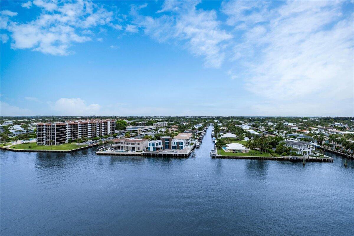 An aerial view of a waterfront neighborhood featuring luxury homes, a canal, and apartment buildings — 3912 S Ocean Boulevard # 1211, Highland Beach FL 33487, HIGHLAND BEACH, FL