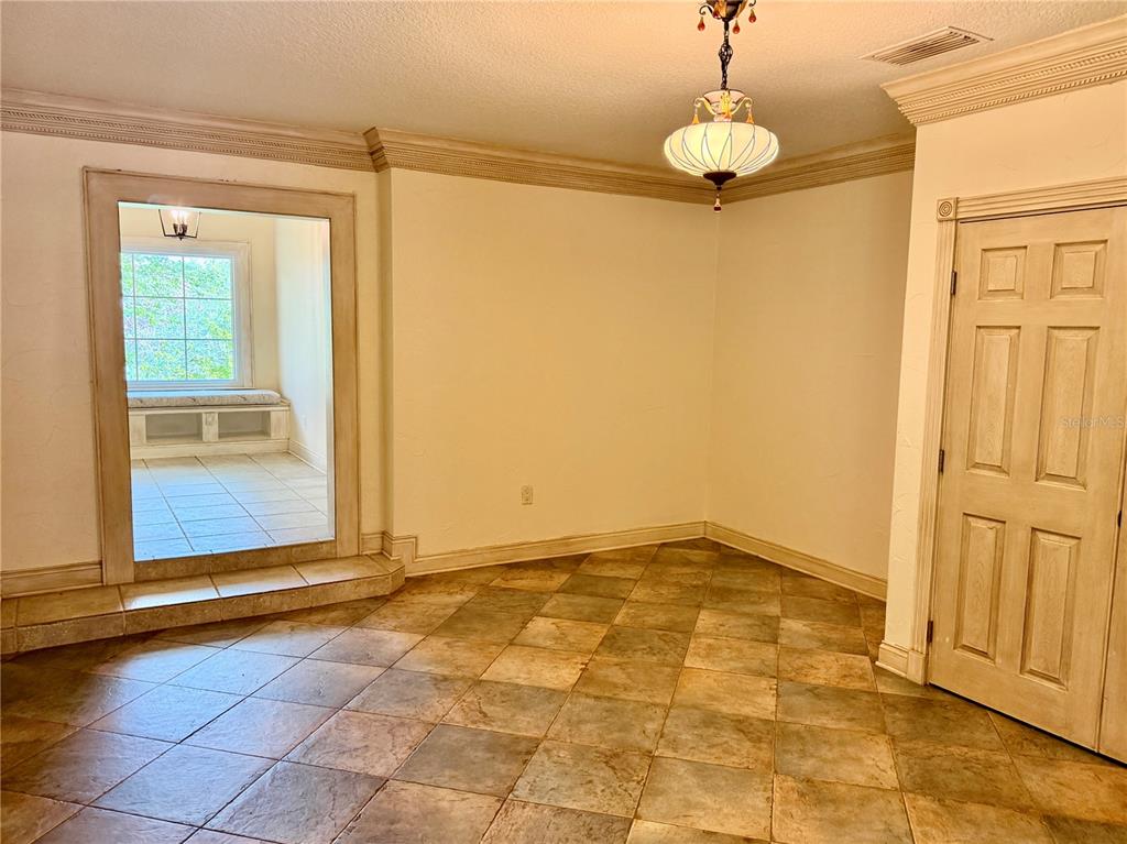 A room with tile flooring, a large wall mirror, and a six-panel wooden door — 430 GEHR LANE, LAKE MARY, FL
