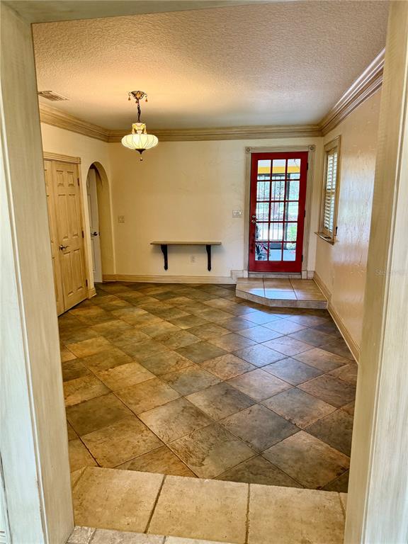 An entryway with tiled floors, a red door, and a wall-mounted shelf — 430 GEHR LANE, LAKE MARY, FL