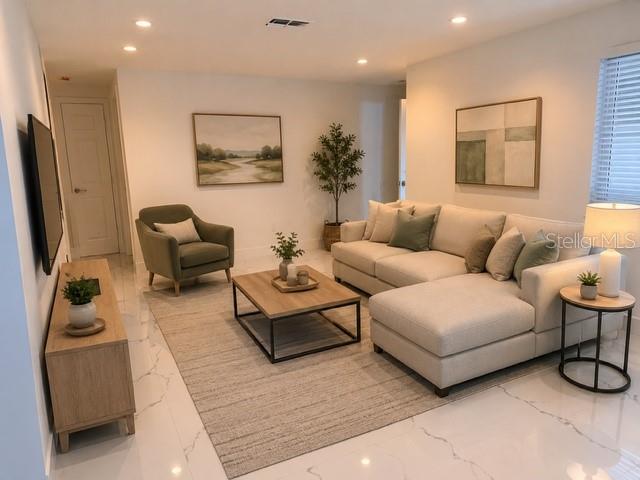 A living room features a beige sectional sofa, a green armchair, and a wooden coffee table — 4453 TERRY LOOP, NEW PORT RICHEY, FL