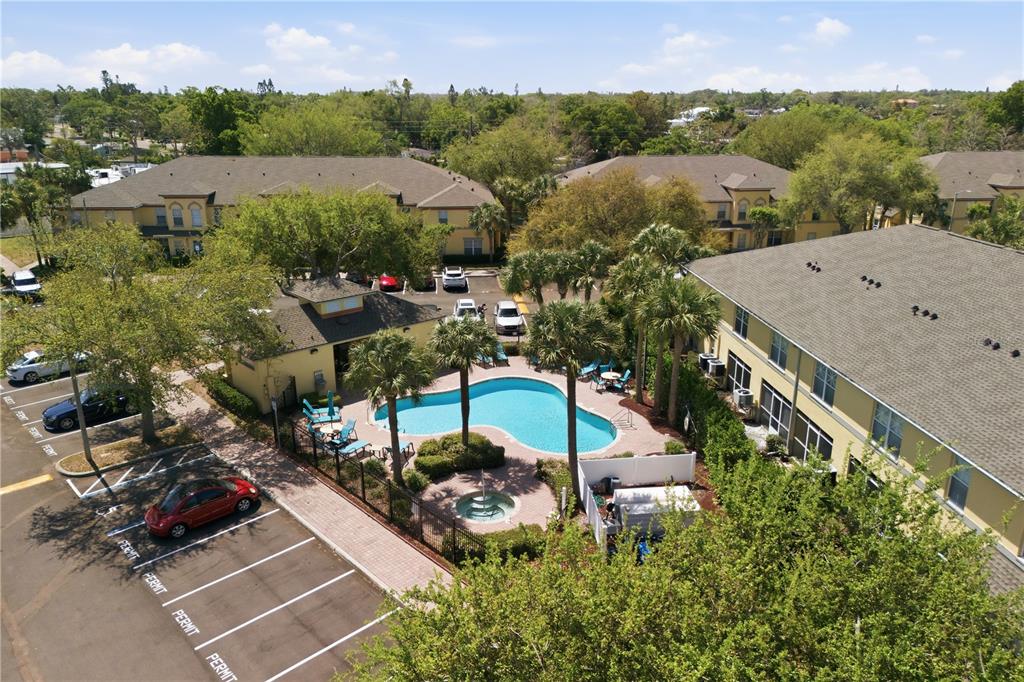 An aerial view shows an apartment complex with a swimming pool and parking lot — 3871 MARINER DRIVE, ST PETERSBURG, FL