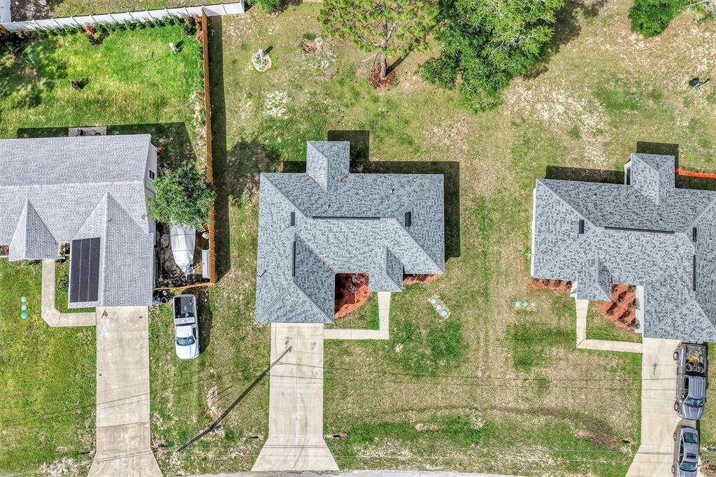 An aerial view shows several single-family homes with driveways and yards in a suburban neighborhood — 42 WATER TRACK DRIVE, OCALA, FL